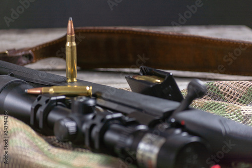 Rifle bolt action sniper weapon gun and ammo isolated on multicam background