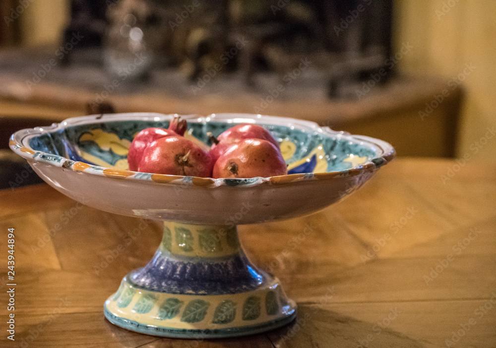 Fruit in Decorative bowl - overhead and depth of field. Pomegranates, grapes and plums - fresh and delicious