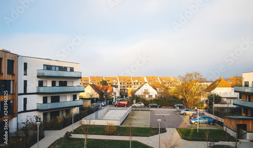 Above view of the interior courtyard of modern townhouses and homes in a residential area with multiple new apartments buildings surrounded by green outdoor facilities in central calm neighborhood