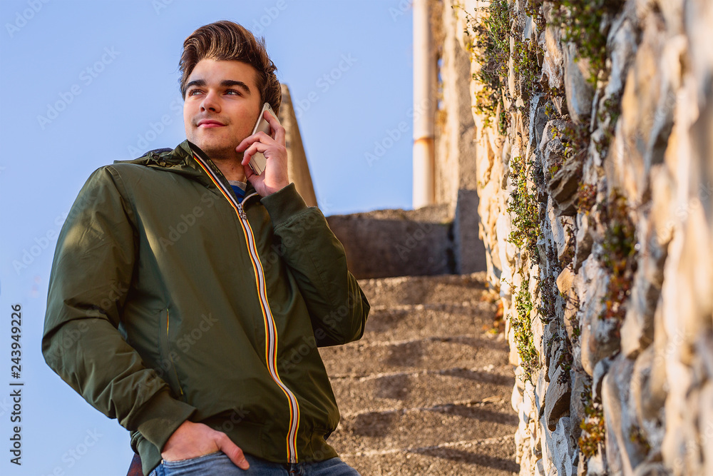 Fototapeta premium Young man at cellphone
