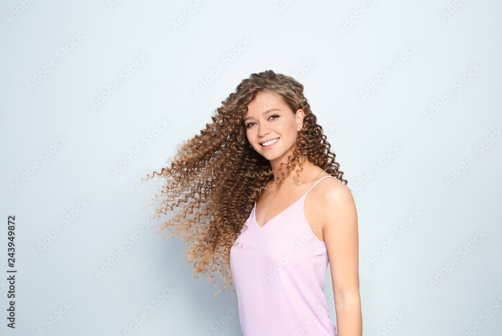 Portrait of beautiful young woman with shiny wavy hair on color background Portrait of beautiful young woman with shiny wavy hair on color background