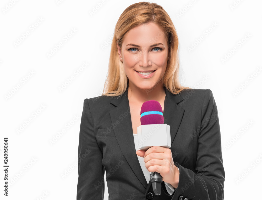 Attractive blonde TV presenter on white background holding a microphone and points to an object.