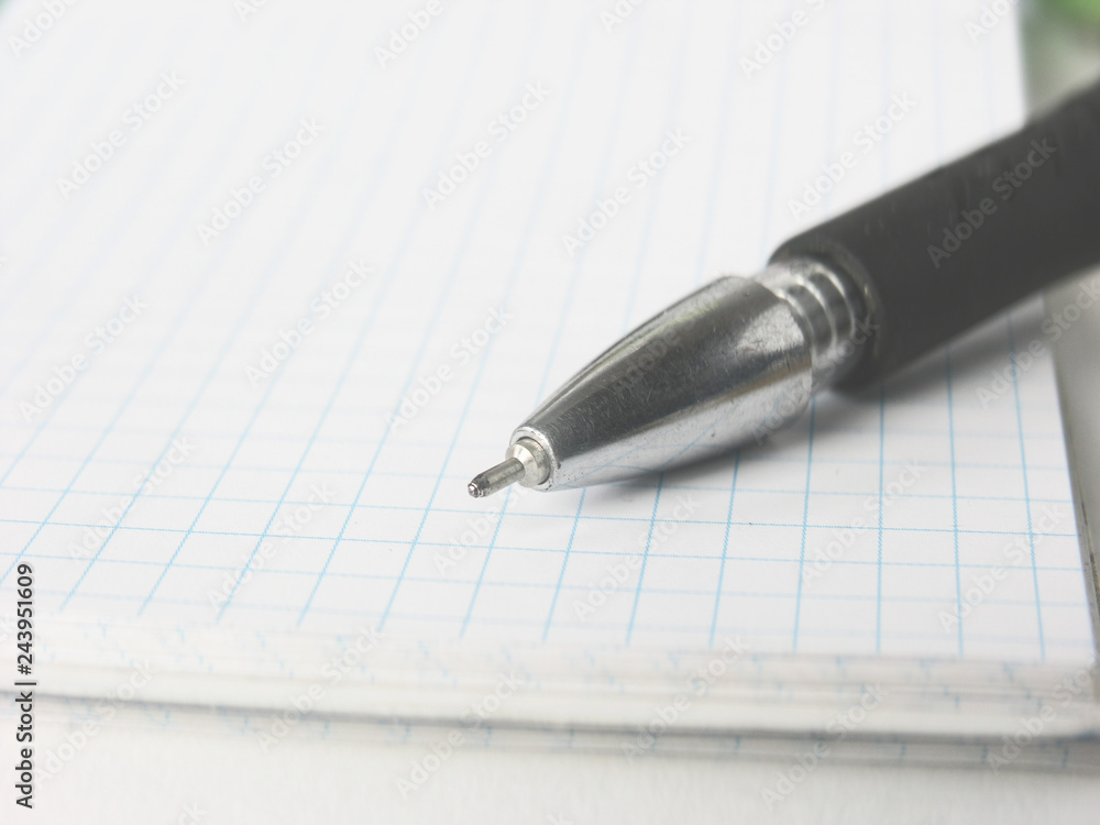 close up.ballpoint pen Notepad on blurred background close up.ballpoint pen Notepad on blurred background