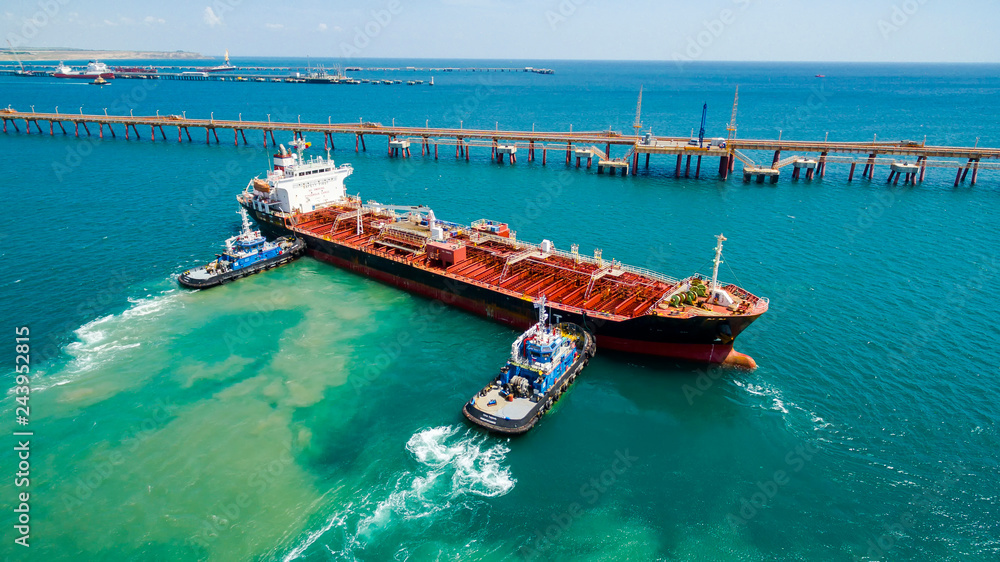 tanker moored to the port using tugs