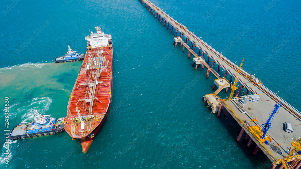 tanker moored to the port using tugs