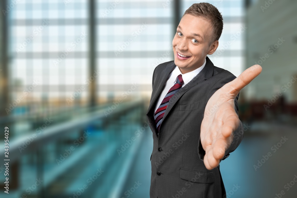 Young happy business man in grey suit