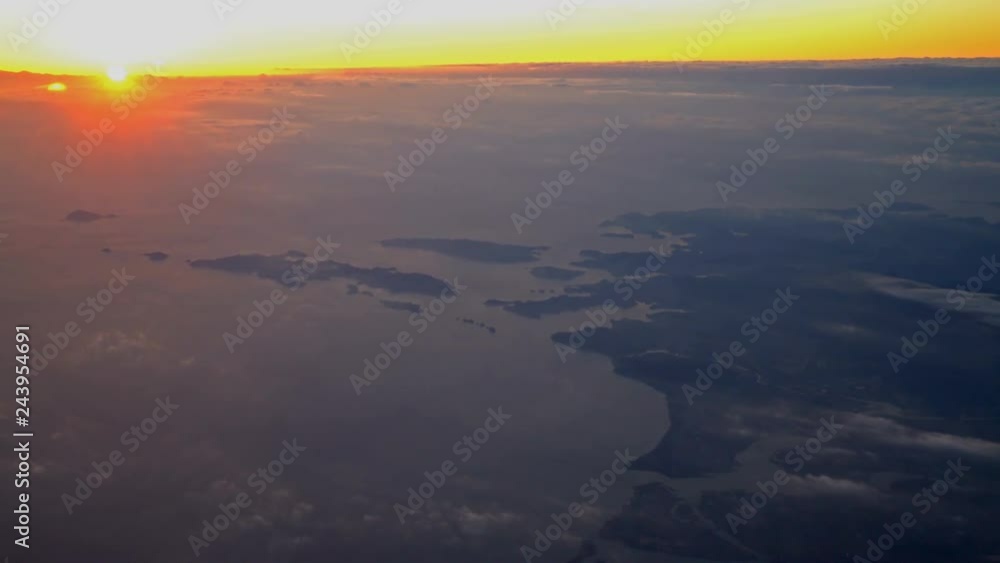 Aerial Shot of Sunrise through Sea of Clouds over Island Aerial Shot of Sunrise through Sea of Clouds over Island