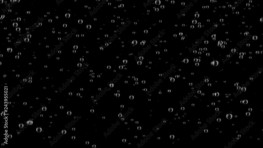 .Close up video of trails of bubbles going up in champagne glasses on gray background with blurred lights in warm tones .Close up video of trails of bubbles going up in champagne glasses on gray background with blurred lights in warm tones