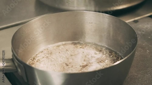 the chef adds seasoning to the porridge photo