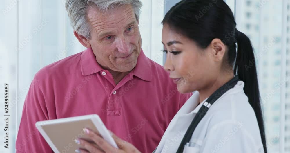 Elderly male patient asking Japanese woman doctor questions about test results Elderly male patient asking Japanese woman doctor questions about test results