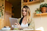 Relaxed woman working from home on her tablet