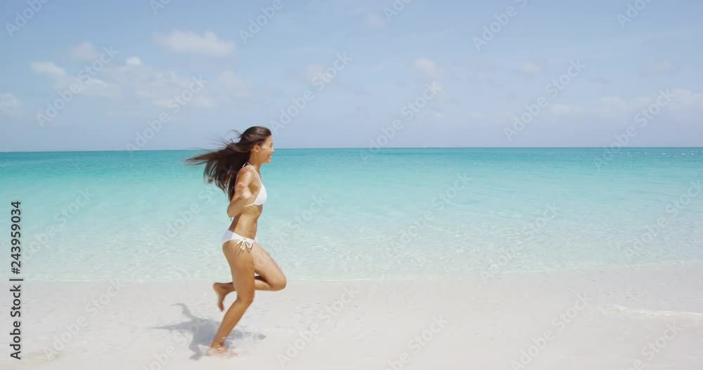 Happy Asian American girl having fun on beach on luxury island. Mixed race woman. RED EPIC STEADICAM SLOW MOTION. Happy Asian American girl having fun on beach on luxury island. Mixed race woman. RED EPIC STEADICAM SLOW MOTION.