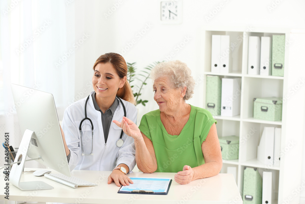 Fototapeta premium Doctor working with elderly patient in hospital