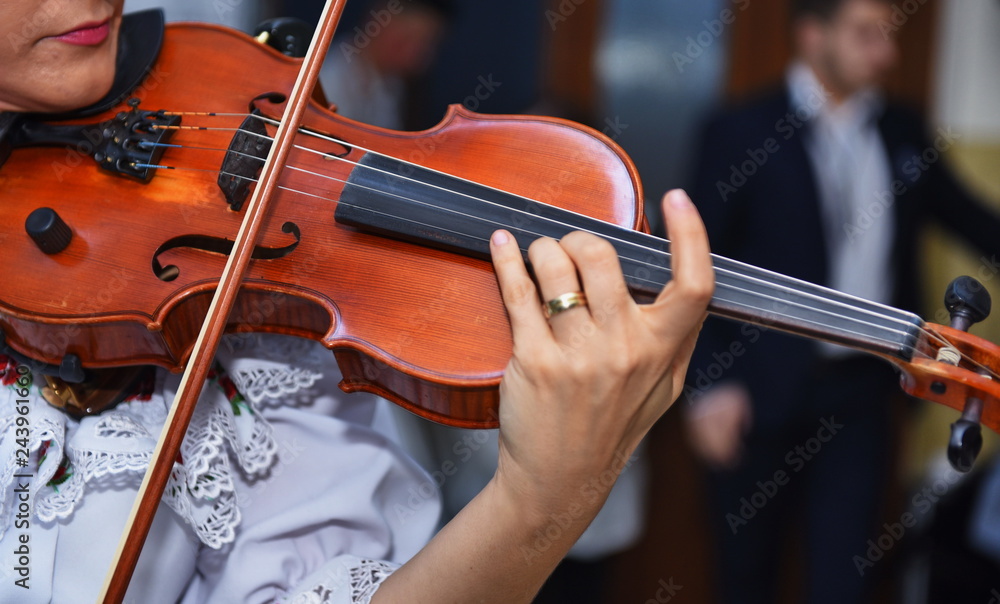 Close view of girls hand on violins strings Close view of girls hand on violins strings