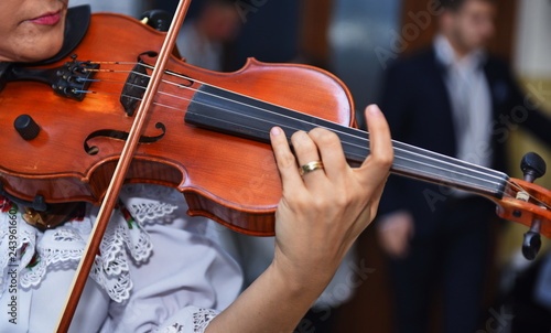 Close view of girls hand on violins strings