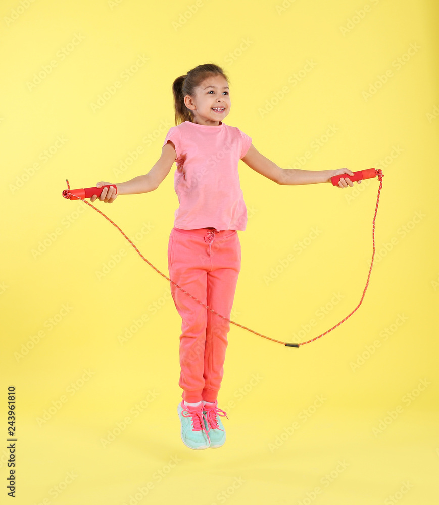 Full length portrait of girl jumping rope on color background Full length portrait of girl jumping rope on color background