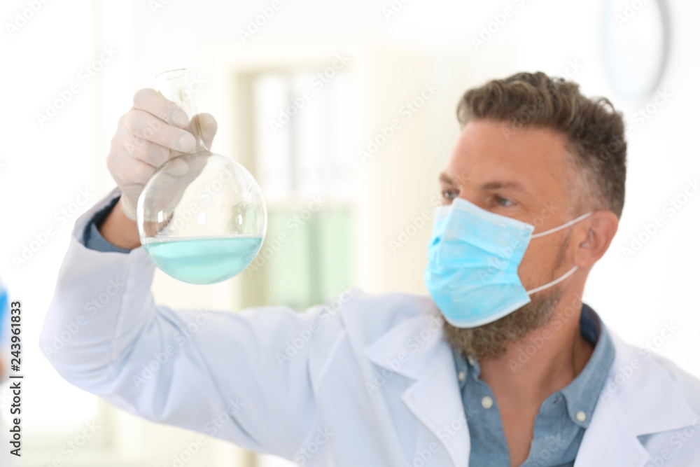 Male scientist with protective mask working in laboratory. Research and analysis Male scientist with protective mask working in laboratory. Research and analysis
