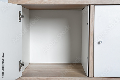 Empty wardrobe compartments, closeup view. Stylish furniture