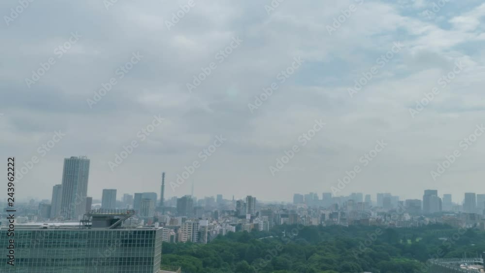 Timelapse of City Skyline over Urban Forest in the Daytime in Tokyo -Pan Right- Timelapse of City Skyline over Urban Forest in the Daytime in Tokyo -Pan Right-