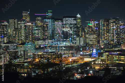 Illuminated Modern City Building Lights Background of Seattle Skyline.