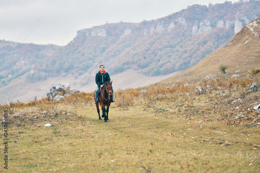 Fototapeta premium man riding a horse nature