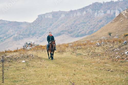 man riding a horse nature
