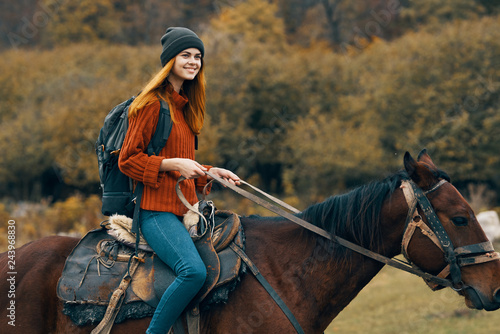 woman smiling riding a horse
