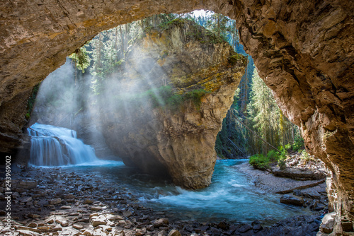 Johnston Canyon cave in Spring season with waterfalls, Johnston Canyon Trail, Alberta, Canada. photo