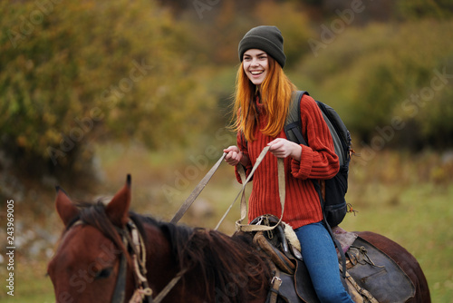 woman riding a horse in the mountains