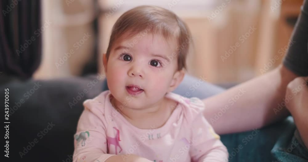 Baby girl standing with the help of her mother. 4K candid, real life footage. Baby girl standing with the help of her mother. 4K candid, real life footage.