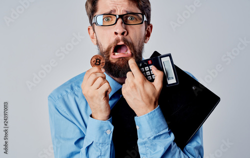 business man with a bitcoin calculator