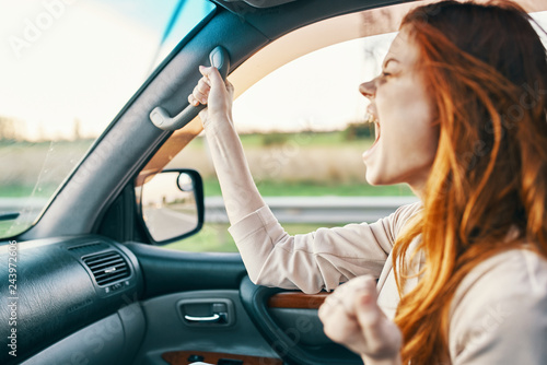 woman riding in car screaming © SHOTPRIME STUDIO