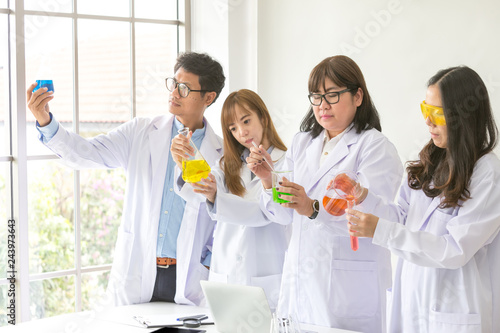Science concept. Chemist scientific testing quality. Team Scientist working at laboratory. One Male and Three Female at chemistry lab. Life scientist researching in laboratory. Asian people.