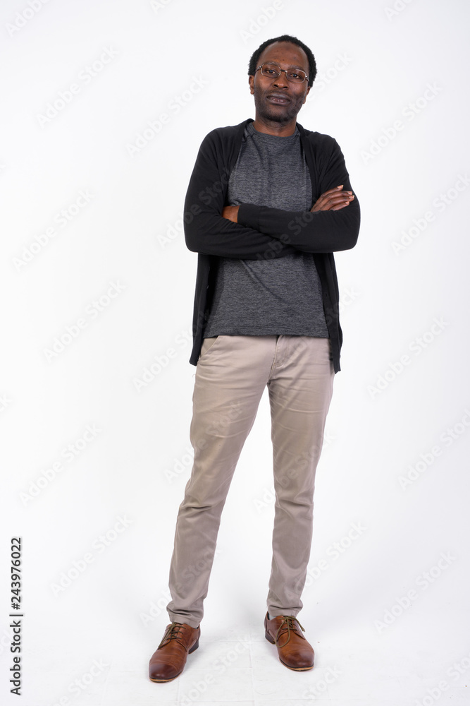 Fototapeta premium Full body shot of handsome African man with arms crossed