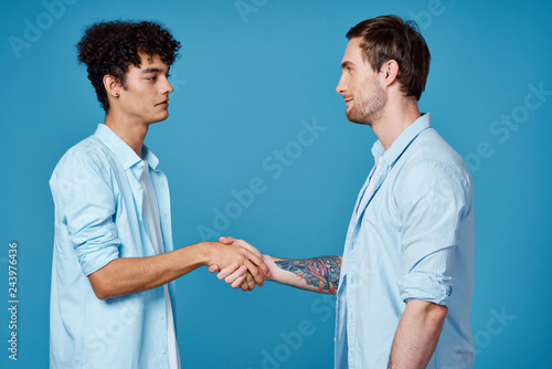 handshake of friends on a blue background