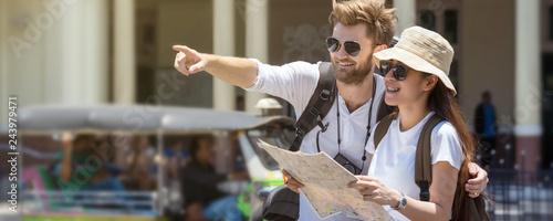 Banner and web page or cover template of Multiethnic Travellers are looking the destination and holding the map at the train station, Travel and transportation concept