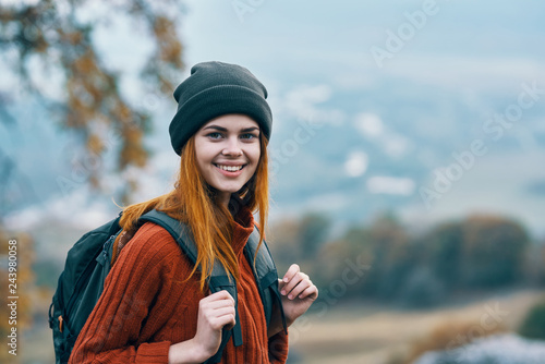 woman with backpack in hat in nature