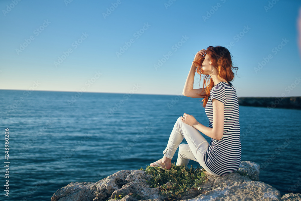 woman sits on the shore by the sea nature