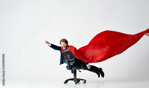 business man the hero in a red raincoat rolls on a chair on an isolated background photo
