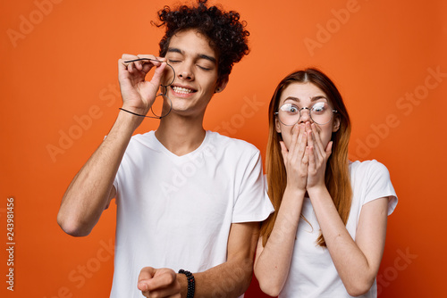 crazy young couple on orange background emotions