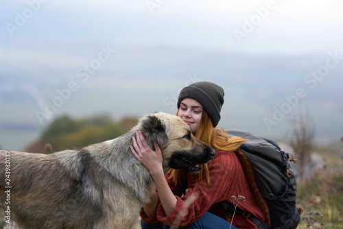 woman petting a dog in the mountains nature © SHOTPRIME STUDIO
