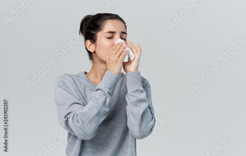 woman blows out sneezing flu