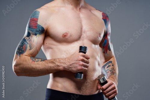 man with dumbbells tattoo on his body