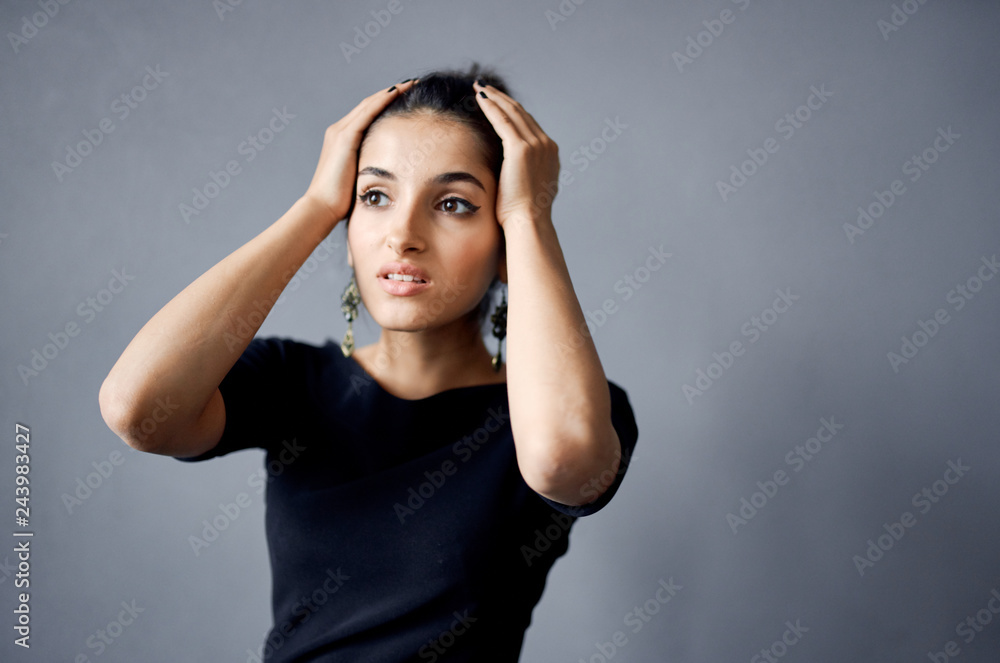 beautiful woman holding hands on her head beautiful woman holding hands on her head