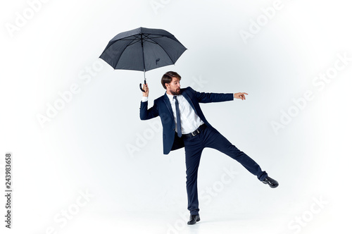business man with umbrella on an isolated background © SHOTPRIME STUDIO