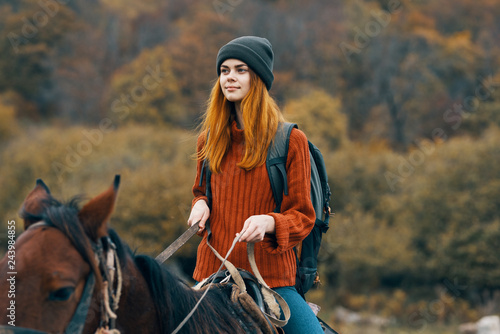 woman riding a horse in nature