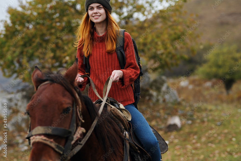 Fototapeta premium woman riding a horse nature