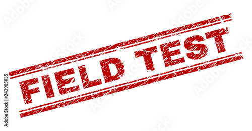 FIELD TEST seal print with corroded texture. Red vector rubber print of FIELD TEST text with unclean texture. Text label is placed between double parallel lines.