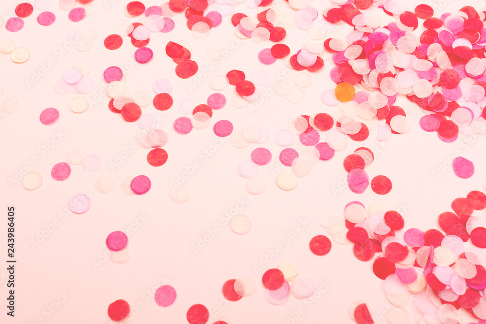 Confetti on pink background.