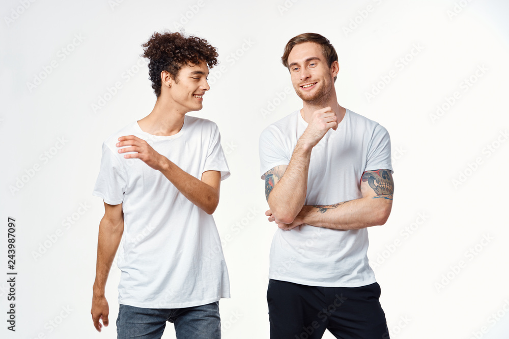 male friends in white t-shirts on an isolated logo background male friends in white t-shirts on an isolated logo background
